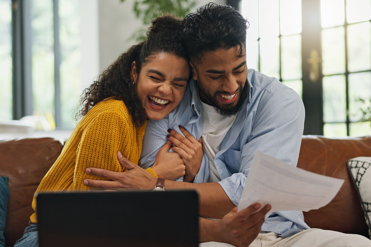 Smiling Couple Applying for a Mortgage